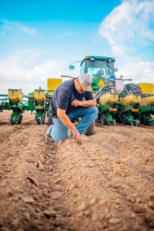 Farmer Checks Seed Depth Behind Planter 56649