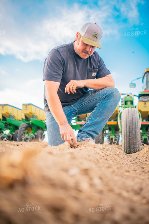 Farmer Checks Seed Depth Behind Planter 56653