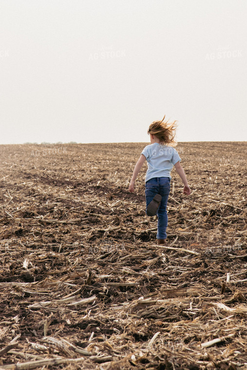 Farm Kid Running in Newly Planted Field 67307