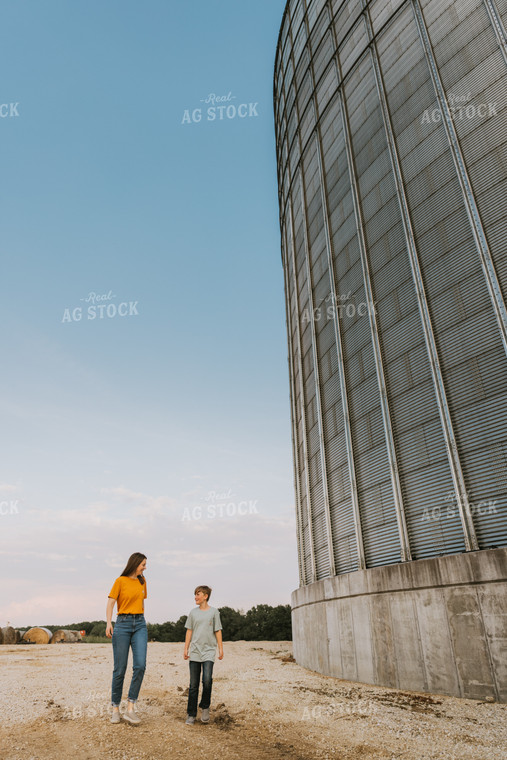 Farm Wife and Son Walk by Grain Bin 7804