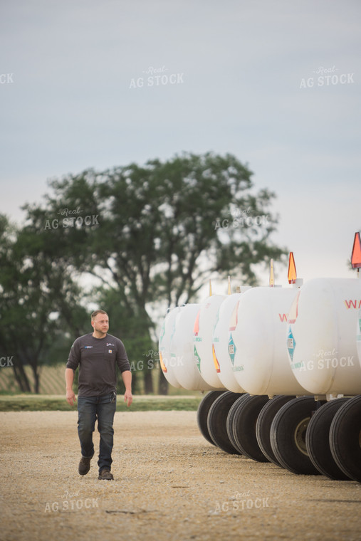 Retailer Walking by Anhydrous Tanks 7898