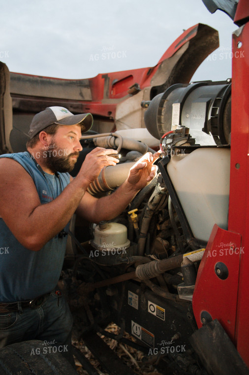 Farmer Fixing Semi Truck 26043