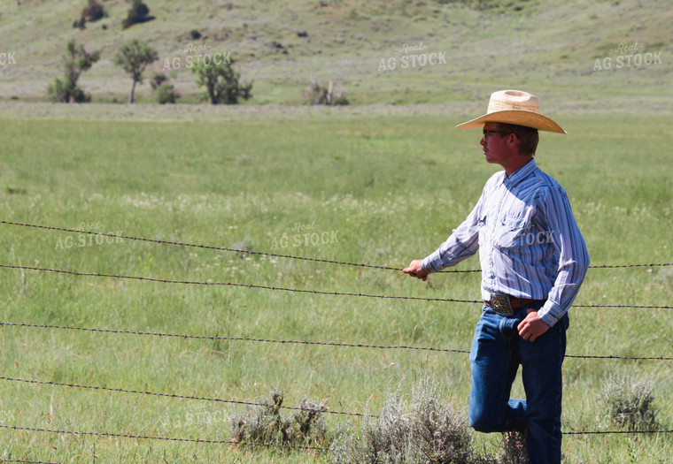 Rancher Leaning on Fence 63078