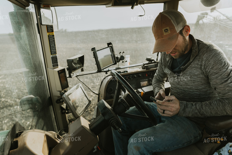 Farmer in Tractor Cab using Phone 8185