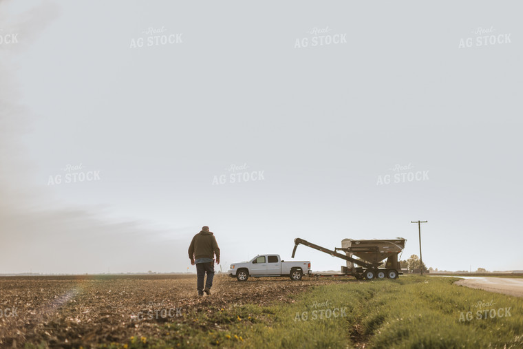 Farmer Walking in Field to Seed Tender 8192