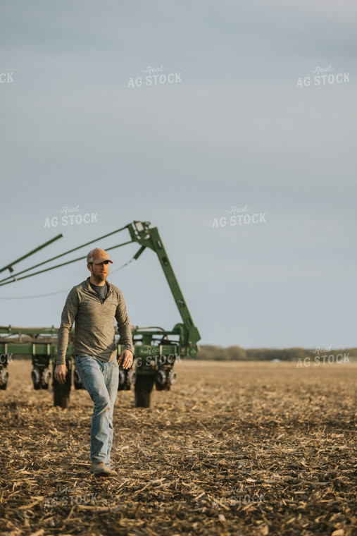 Farmer Walking in Field by Planter 8213