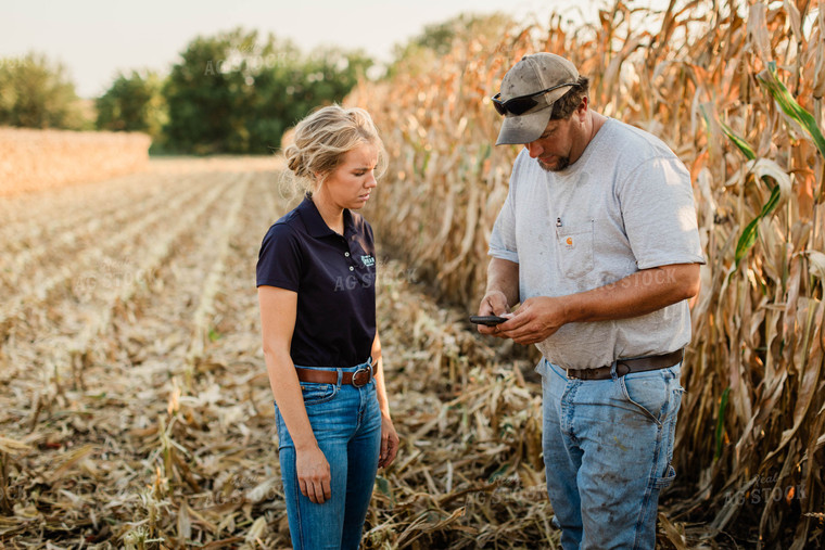 Farmer and Agronomist Using Phone in Field 8293