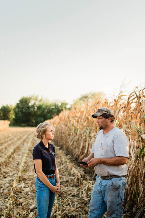 Farmer and Agronomist Using Phone in Field 8294