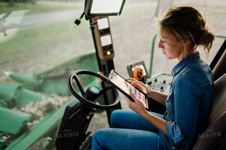 Female Farmer on Tablet in Combine Cab 8397