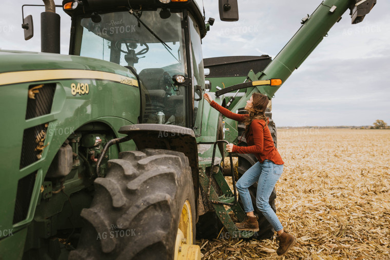 Female Farmer Cimbing into Tractor 8550