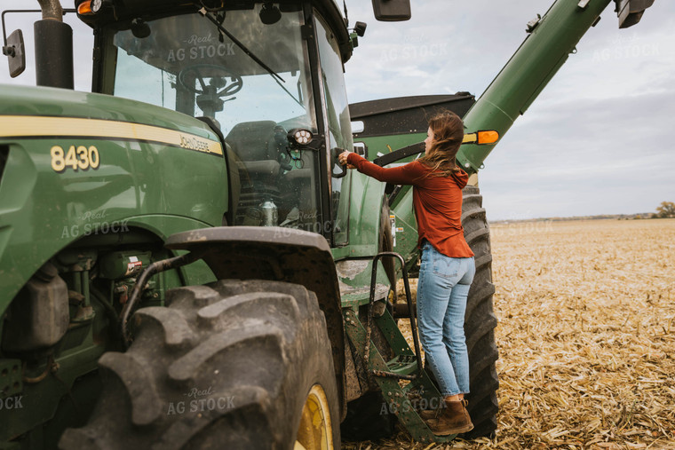 Female Farmer Cimbing into Tractor 8551