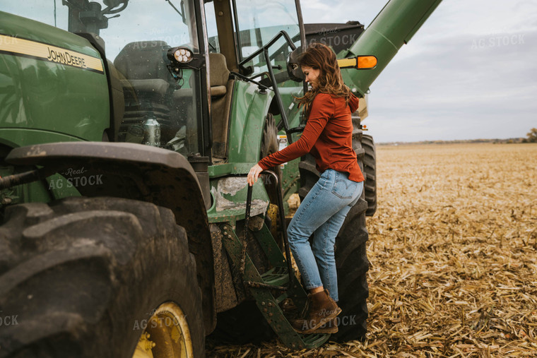 Female Farmer Cimbing into Tractor 8552