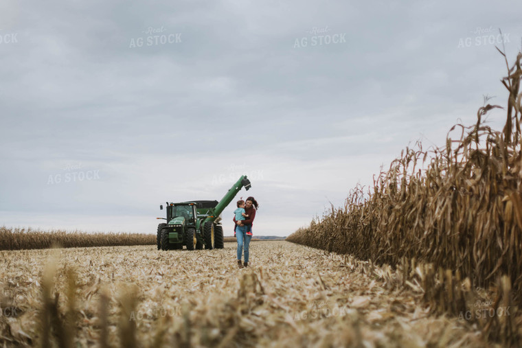 Female Farmer with Daugther Walking Away from Tractor 8608