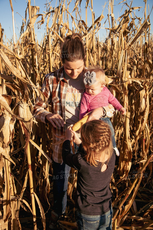 Female Farmer and Kids Checking Corn 67547