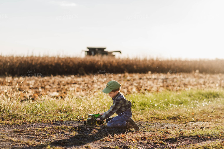 Farm Kid Playing with Toy Tractor 115129