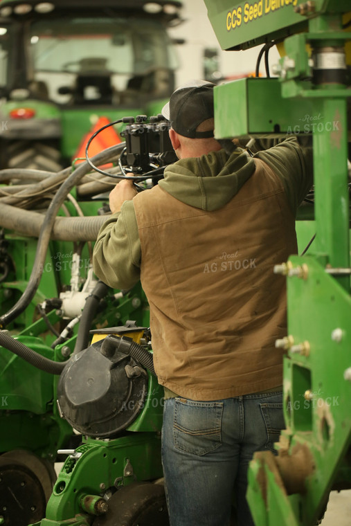 Farmer Fixing Planter 161143