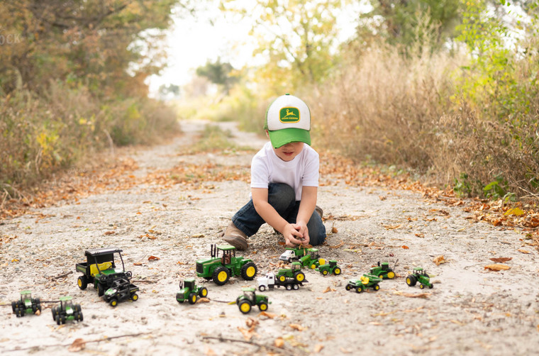 Farm Kid Playing with Toy Tractors 185072