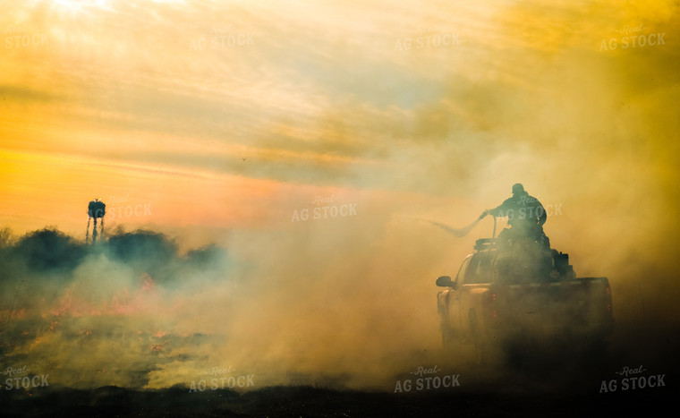 Firefighter Putting out Field Fire 214009