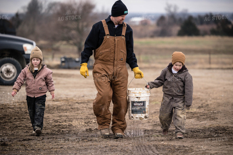 Farmer and Farm Kids Feeding Cattle 219003