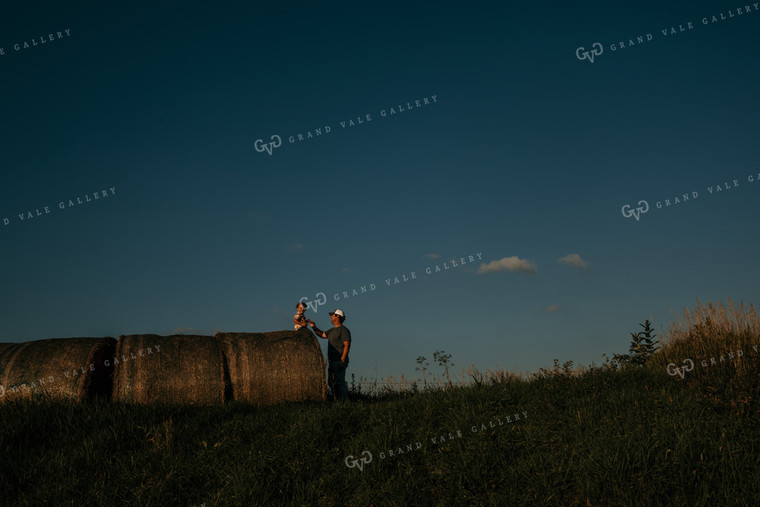 Farmer with Child Hay Bales 3169