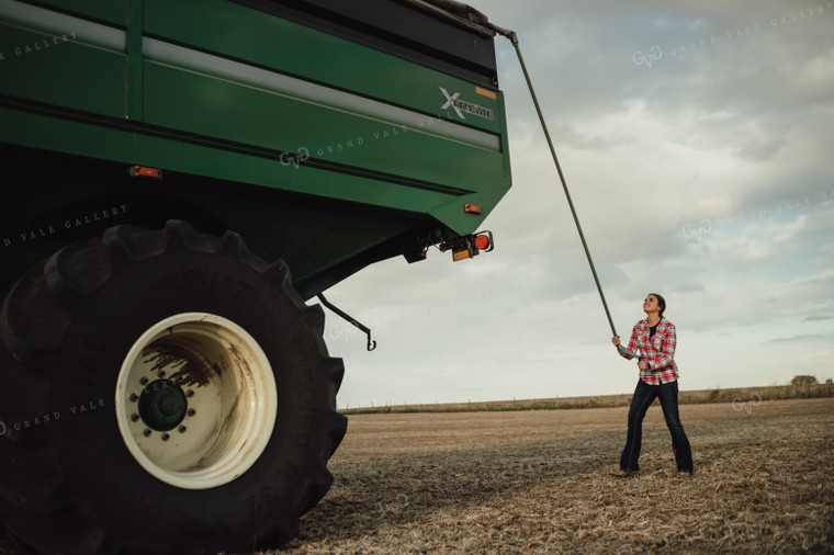 Female Farmer Tarping Grain Cart 3436