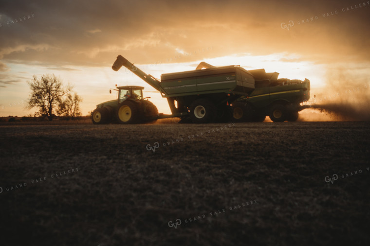Combine Unloading on the go into Grain Cart at Sunset 3462