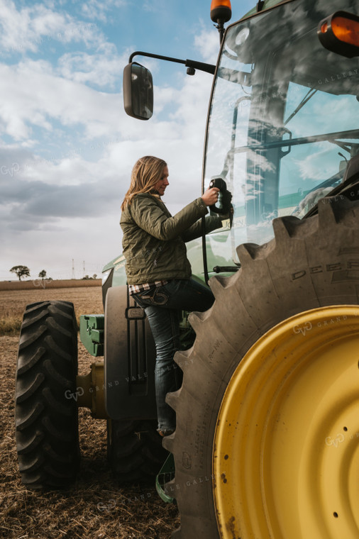 Female Farmer Getting in Tractor 3511