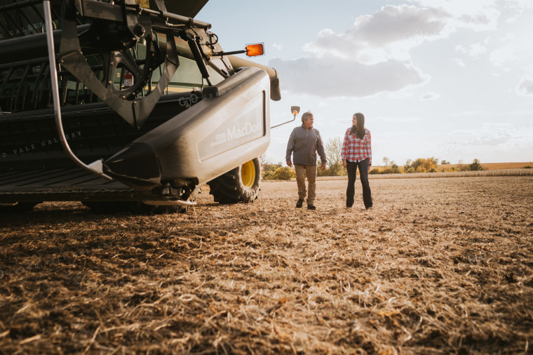 Farmer and Female Farmer Talking Outside of Combine 3521