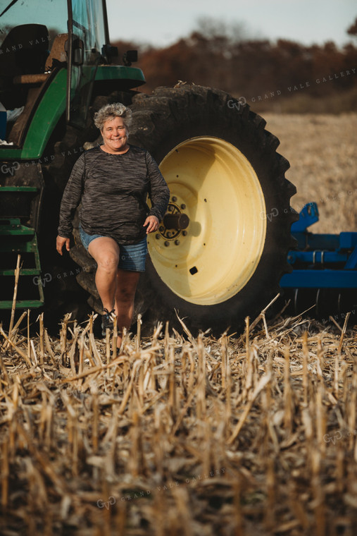 Female Farmer Getting out of Tractor with Disk 3623