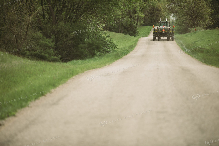 Tractor and Planter Driving Down Road 4013