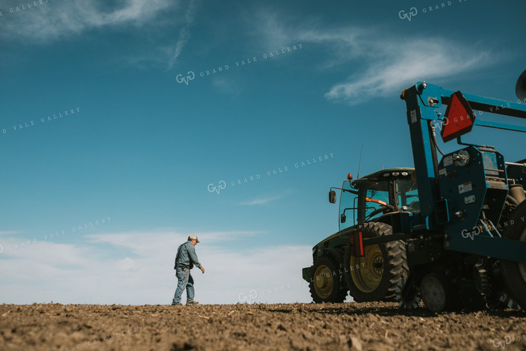 Farmer Climbing out of Tractor with Planter 4100