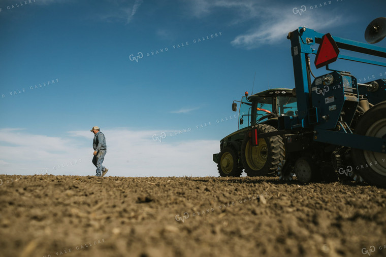 Farmer Climbing out of Tractor with Planter 4103