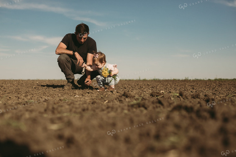 Farmer and Daughter Checking Seed Depth 4175