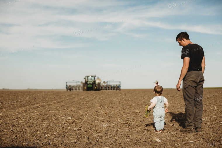 Farmer and Daughter with Tractor and Planter in Background 4185