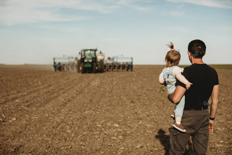 Farmer and Daughter with Tractor and Planter in Background 4186