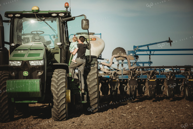 Farmer and Daughter Climbing into Tractor with Planter 4194