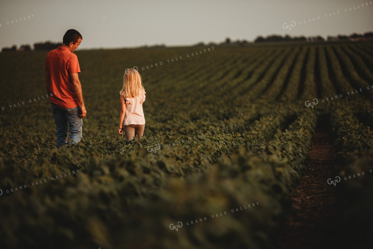 Farmer and Farm Kid Checking Crops in Soybean Field 4586