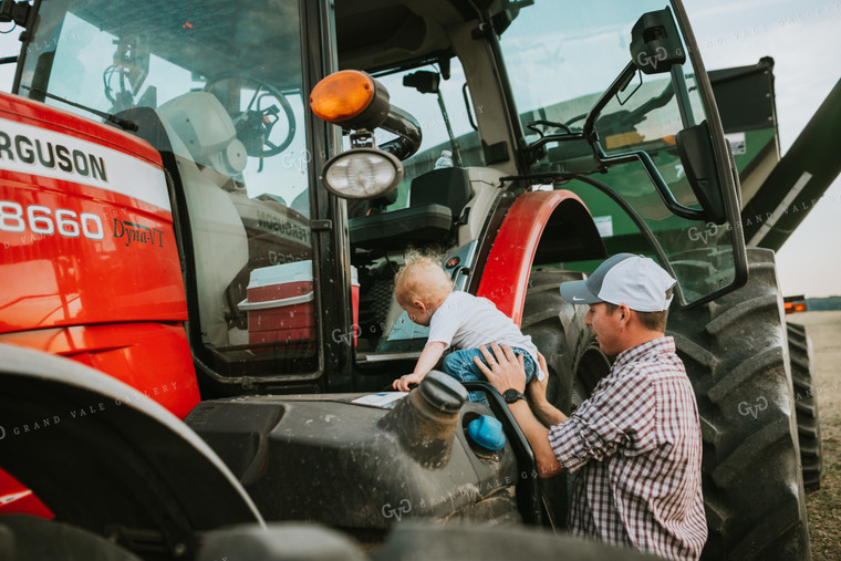 Farmer Taking Farm Kid into Tractor with Grain Cart 4983