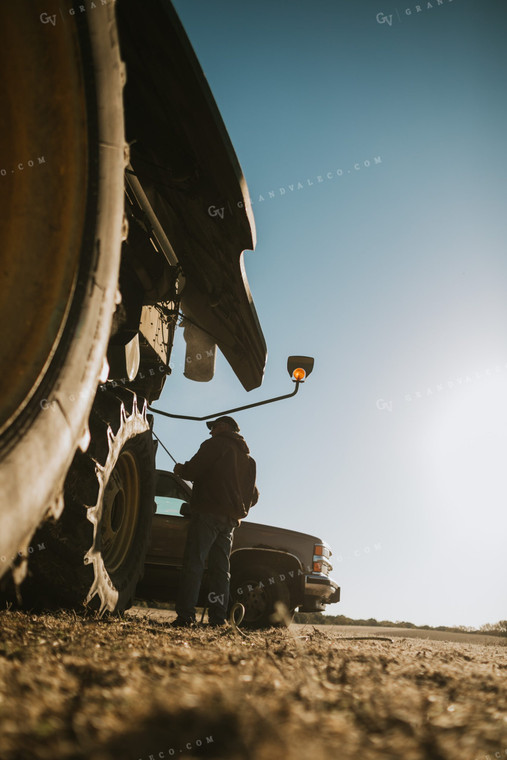 Farmer Using Air Hose to Clean Combine During Soybean Harvest 5196