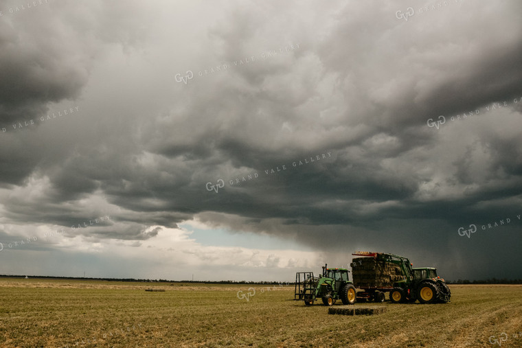 Loading Small Square Bales with Storm in Background 64007