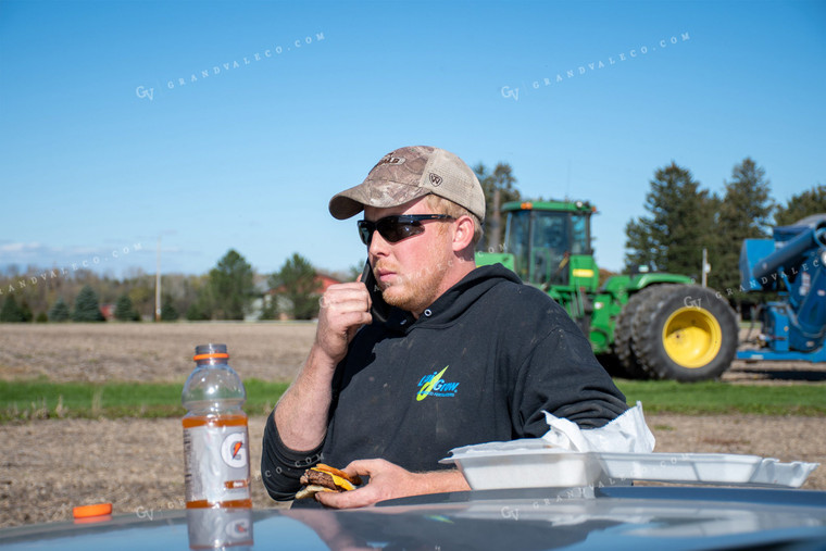 Farmer on Phone Eating Lunch 50193