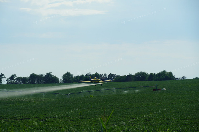 Crop Duster Flying Over Irrigation Pivot and Soybean Field 65003
