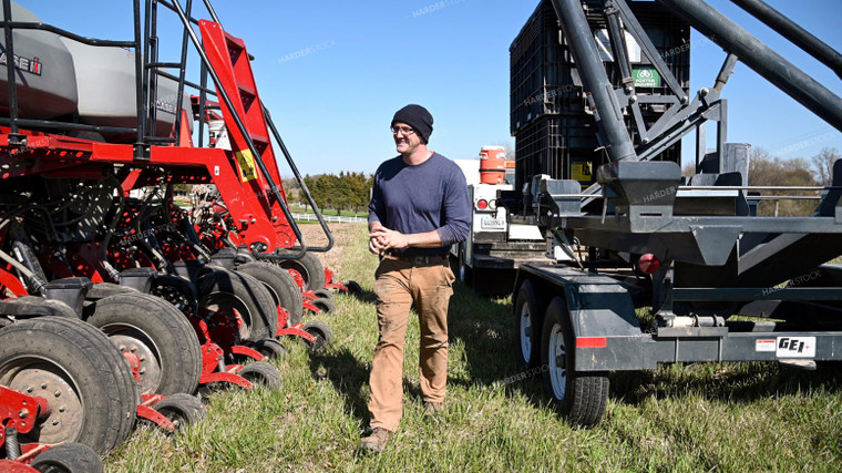 Farmer Loading the Planter with the Seed Tender 25118