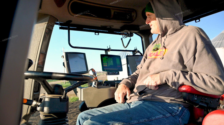 Farmer in the Tractor Cab with Technology 25182