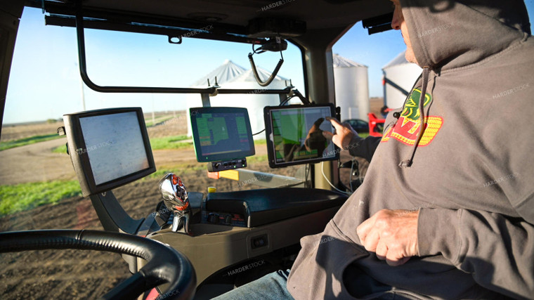 Farmer in the Tractor Cab with Technology 25185