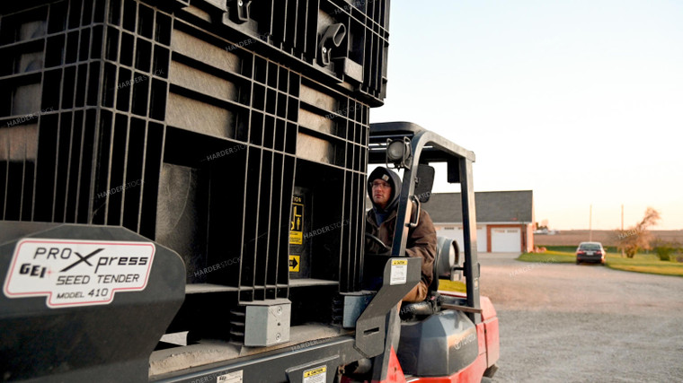 Farmer Loading the Seed Tender with a Skidsteer 25189