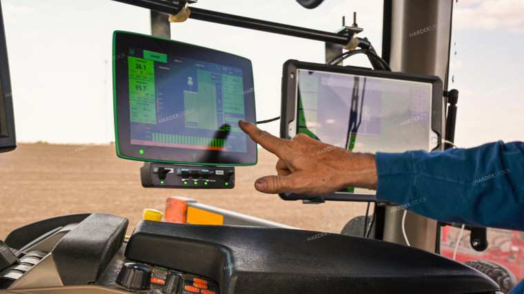 Farmer in the Tractor Cab with Technology 25234