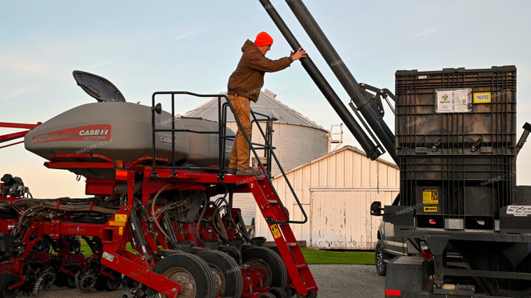 Farmer Climbing into Tractor Cab 25342