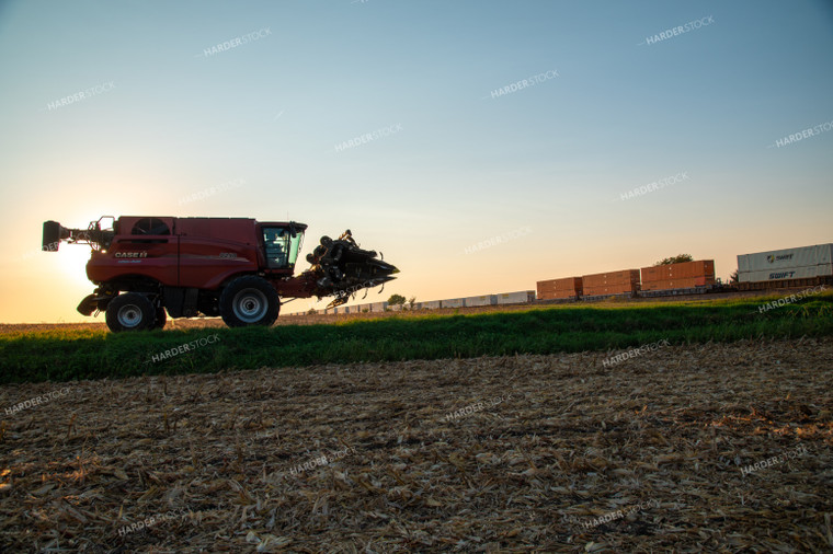 Combine Waiting for Train at Railroad Tracks 25448