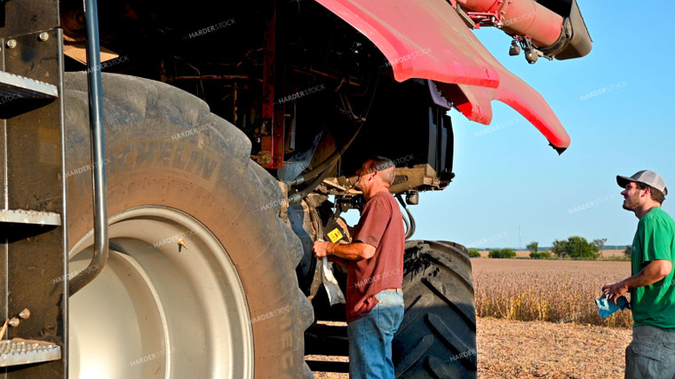 Multigenerational Farm Familiy Repairing Combine in a Bean Field 25519